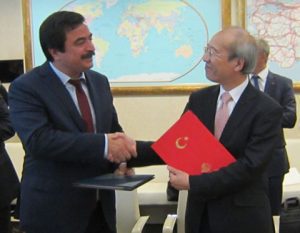Yuichi Yamaura, JAXA vice president (right), and H.E. Dr.Kanlıgöz, director general of Ministry of Transport, Maritime Affairs and Communications of the Republic of Turkey (left), shake hands after signing a collaboration agreement.